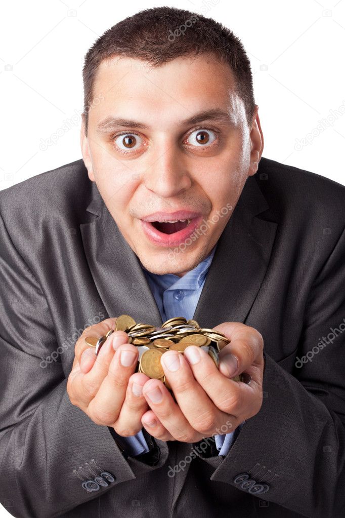Emotional crazy young businessman with heap of coins isolated on