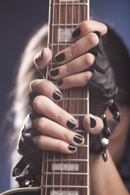 Girl holding her guitar clipart
