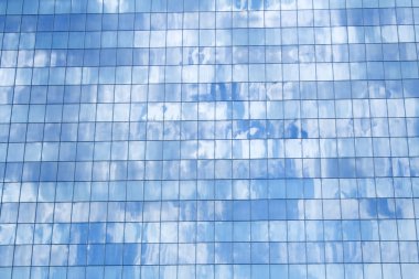 Glass facade building detail reflecting sky clipart