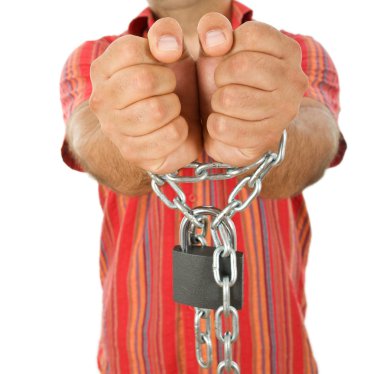 Man in chains - closeup, focus on hands clipart