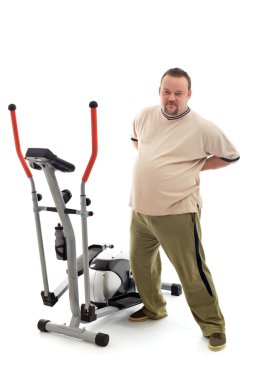 Overweight man stretching his back near a trainer device clipart