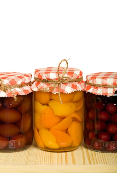 Canned fruits on the shelf - isolated — Stock Photo, Image