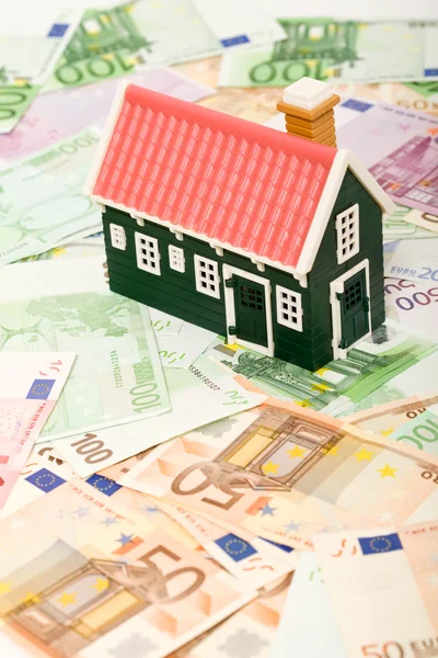 Миниатюрный дом на поле для банкнот евро — стоковое фото