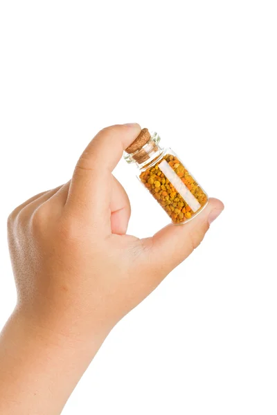Piccola bottiglia con polline in mano bambino — Foto Stock