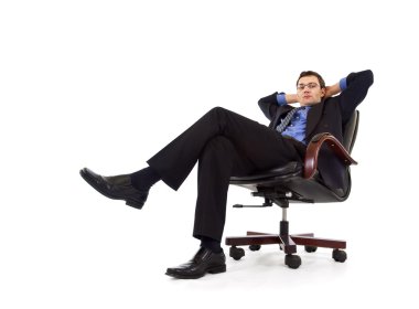 Businessman relaxing in armchair clipart