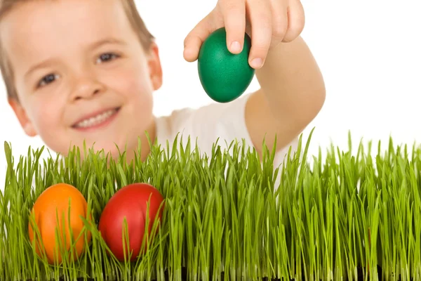 Happy boy with easter eggs in the grass — Stock Photo, Image