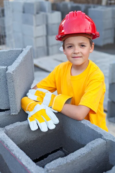 Boy learning the tricks of trade at a construction site — Stock Photo, Image