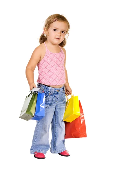 Renkli alışveriş torbaları ile küçük kız — Stok fotoğraf