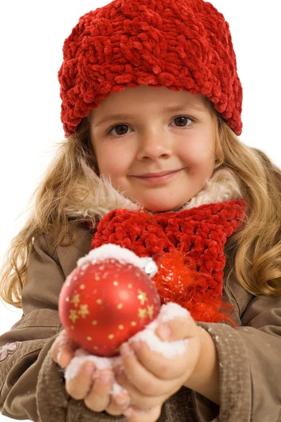 Little girl holding a christmas ball in snow — Stock Photo, Image