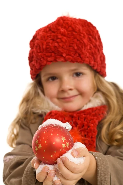 Little girl with warm clothes holding christmas ball — Stock Photo, Image