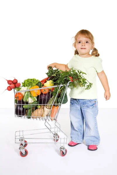 Little girl with vegetables in a shopping cart — Stock Photo, Image
