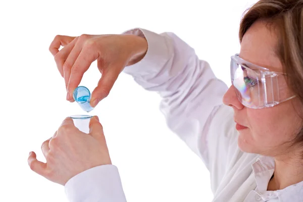 Woman with chemical flasks and protective glasses — Stock Photo, Image