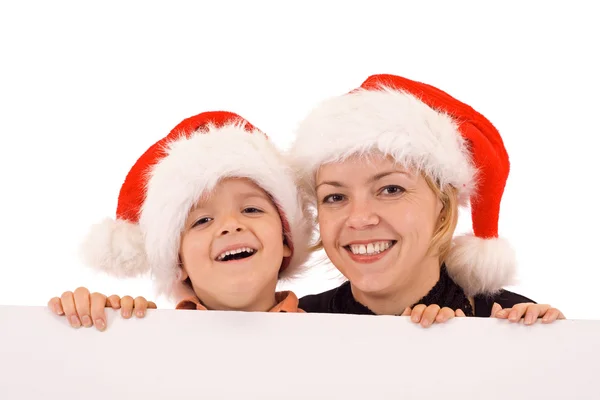 Weihnachtsmänner hinter weißem Banner — Stockfoto