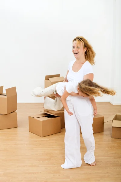 Happy woman and little girl in a new home — Stock Photo, Image