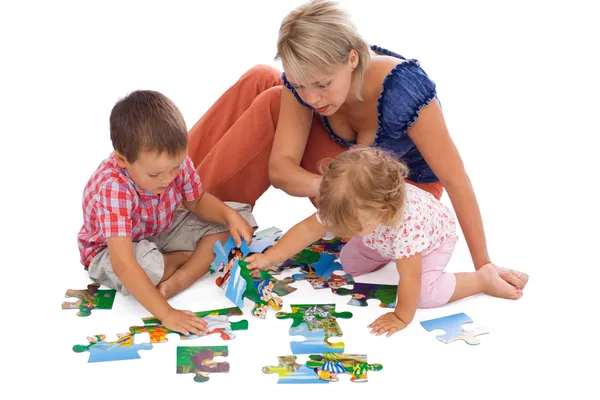 Family playing with puzzle — Stock Photo, Image