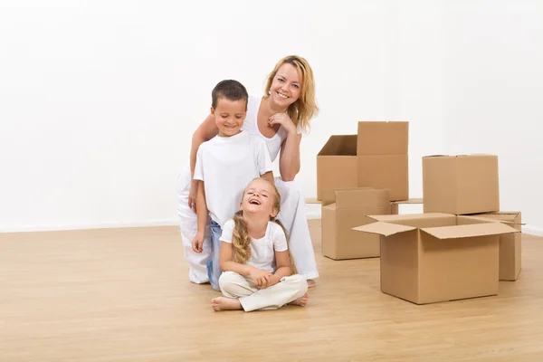 Kids and woman in their new big home — Stock Photo, Image