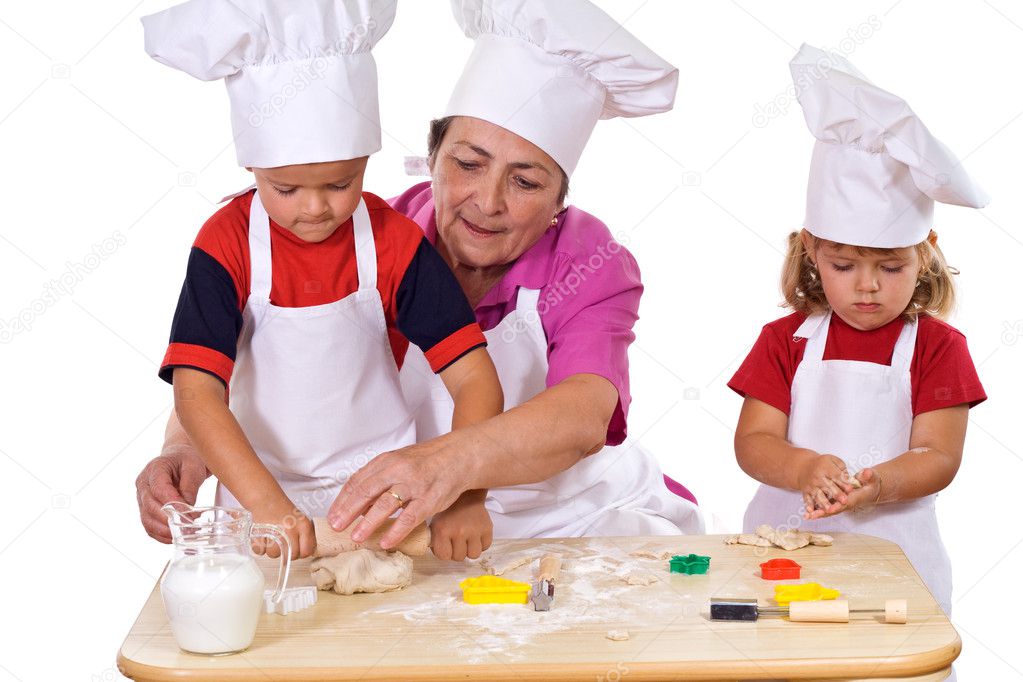 Grandmother teaching kids how to make cookies
