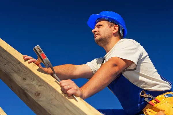Carpenter on top of roof structure Royalty Free Stock Photos