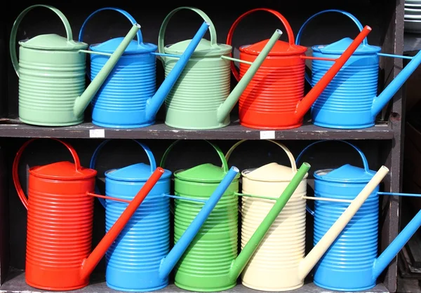 Colorful watering cans — Stock Photo, Image