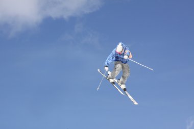 Flying skier on mountains clipart