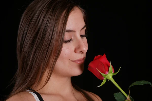 Woman smelling a red rose — Stock Photo, Image