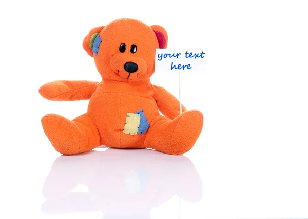 Teddy bear holding a tag — Stock Photo, Image