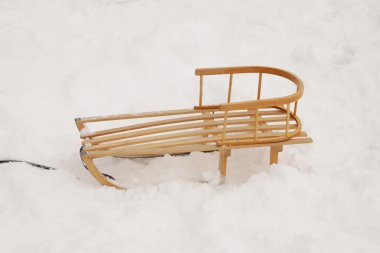 Wooden sledge in the snow clipart