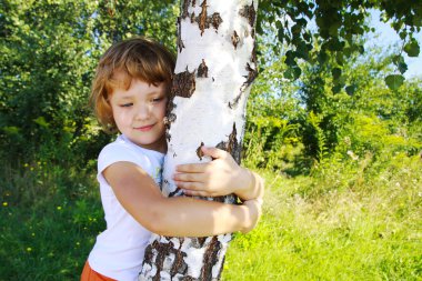 Care for nature - little girl embrace a tree clipart