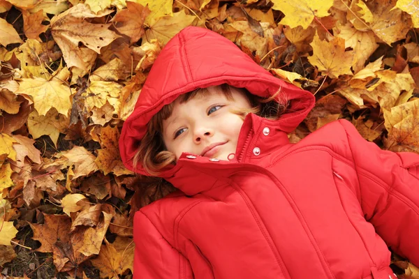 Autumn - the girl is in the yellow leaves — Stock Photo, Image