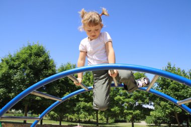 The four-year girl playing on the playground