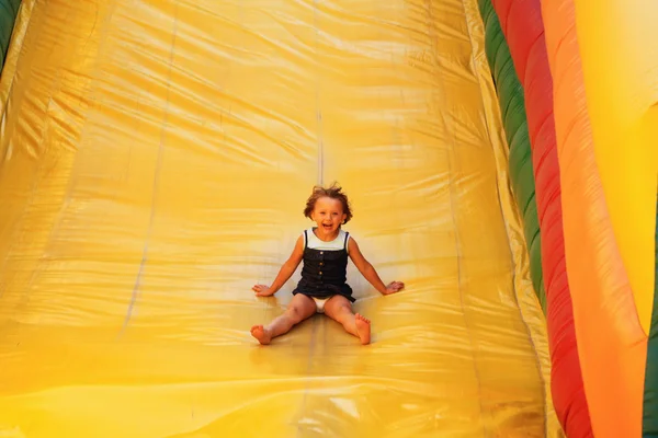 Young girl on the air slide — Stock Photo, Image