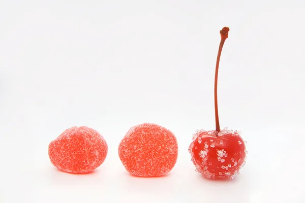 Cocktail cherry and red candies in the line — Stock Photo, Image