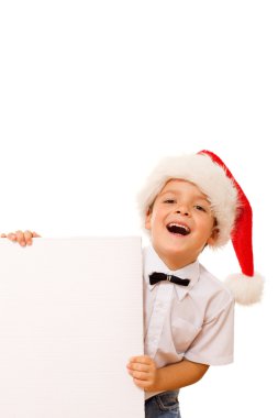 Laughing christmas boy with santa hat and blank sign clipart