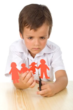 Sad kid cutting up paper family - divorce concept clipart