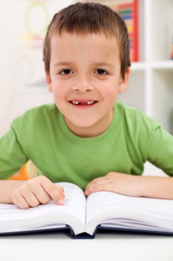 Happy elementary school boy practice reading clipart