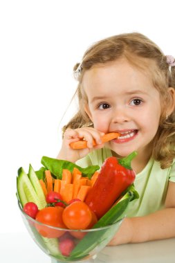 Little girl tasting and chomping a carrot clipart