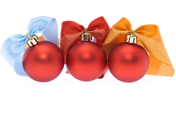 Three red christmas balls with assorted ribbons — Stock Photo, Image