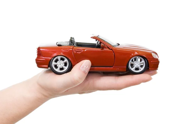 Woman hand with holding red sports car — Stock Photo, Image