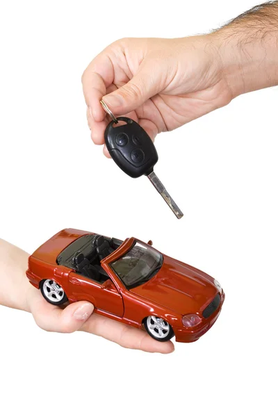 Ręce z czerwony sportowy samochód i klucz — Zdjęcie stockowe