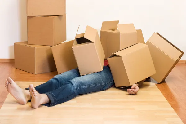 Man covered in cardboard boxes - moving concept — Stock Photo, Image