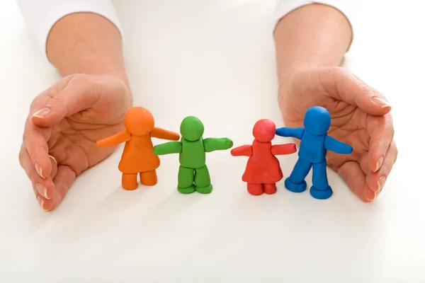 stock image Woman hands protecting clay family