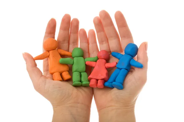 Woman hands holding colorful clay family — Stock Photo, Image