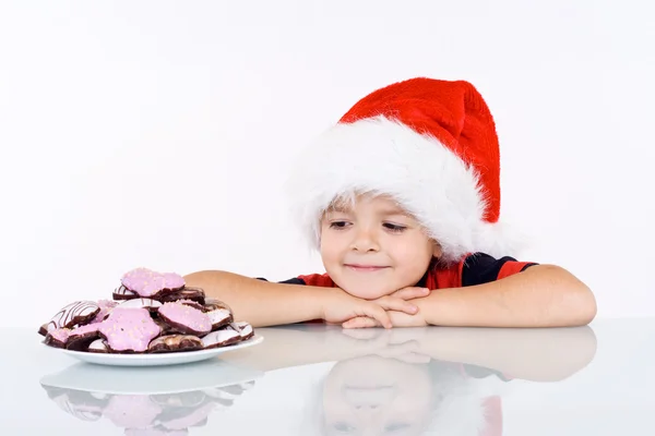 Boy admiring the christmas gingerbread cookies — Stock Photo, Image