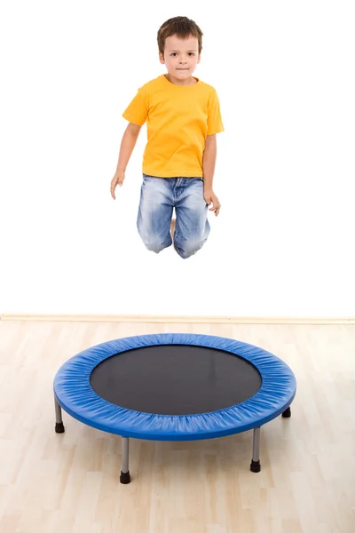 Boy jumping high on trampoline — Stock Photo, Image