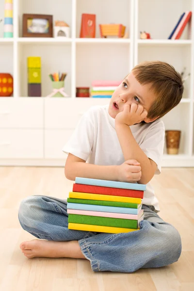 Bored kid with lots of school books — Stock Photo, Image