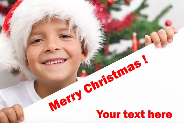 Happy boy with christmas hat and white banner — Stock Photo, Image