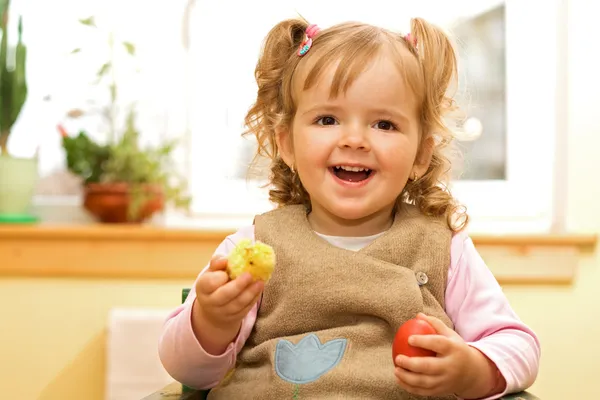 Happy girl with easter egg and decoration in hands — Stock Photo, Image