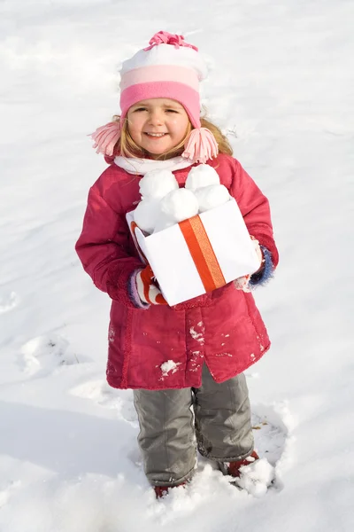 Happy little girl with a box of snowballs — Stock Photo, Image