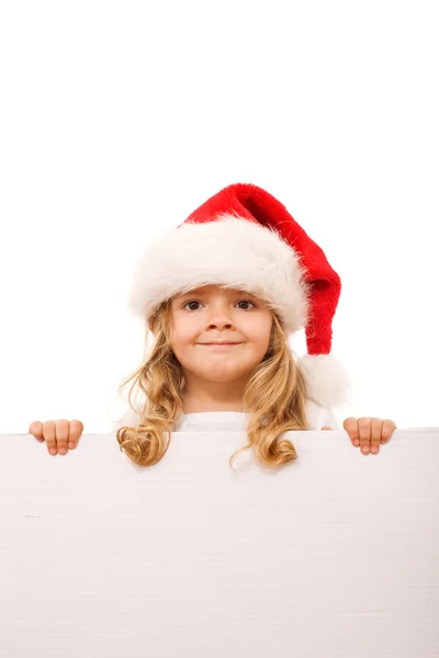 Little girl with santa hat and cardboard banner — Stock Photo, Image