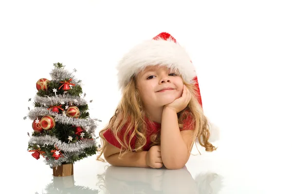 Little girl with small christmas tree — Stock Photo, Image